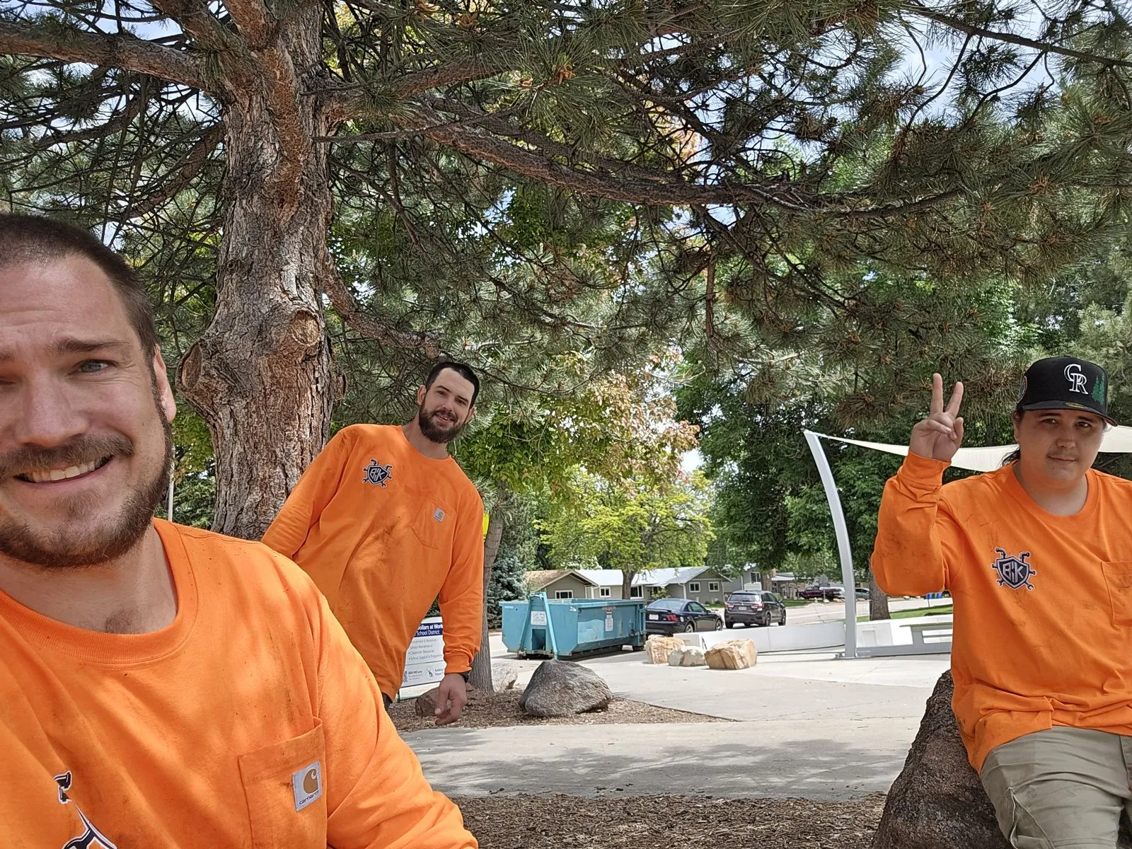 The BCK crew in orange shirts on a lunch break at a school job