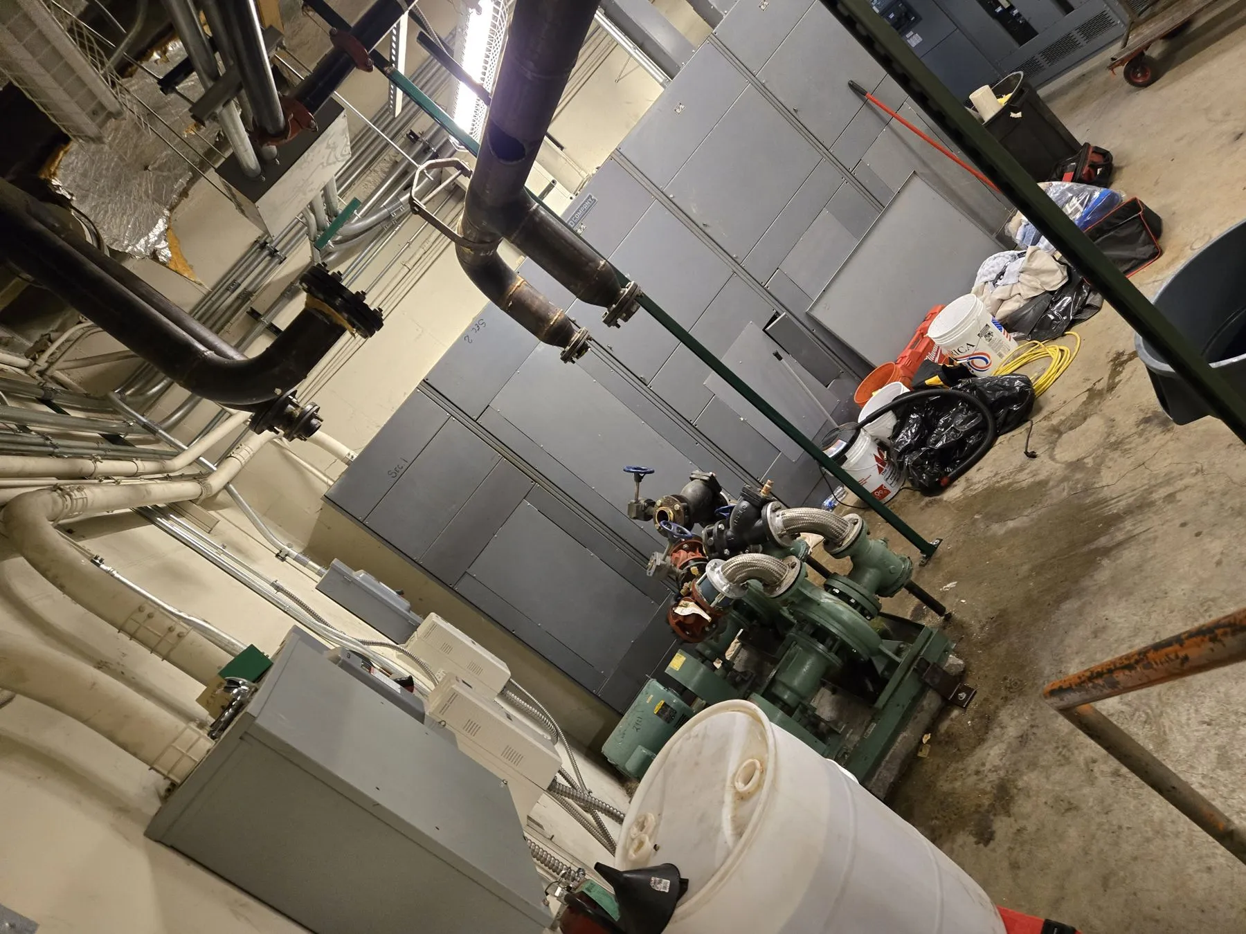 Mechanical room piping, pumps and tanks staged for removal